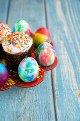 Easter kulich and decorated eggs. place for text on turquoise wooden background. a traditional holiday treat.