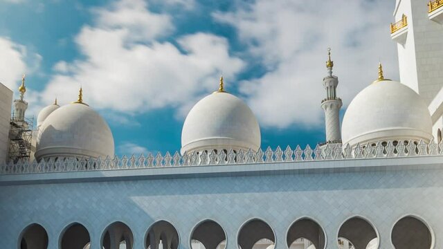 Pool with water at Sheikh Zayed Grand Mosque timelapse hyperlapse located in Abu Dhabi - capital city of United Arab Emirates. It is largest mosque in UAE. Blue cloudy sky
