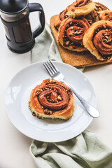 Cinnamon rolls buns on a white plate simple background 