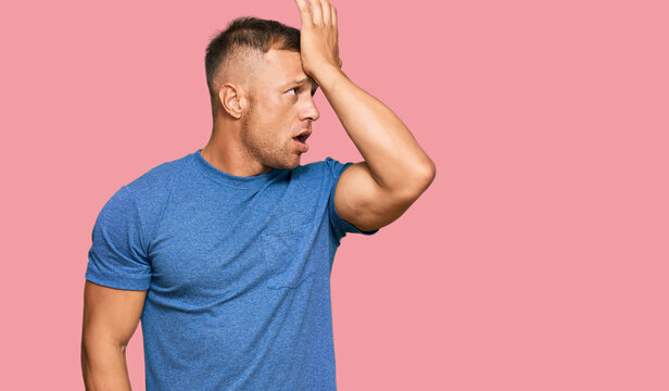 Handsome muscle man wearing casual clothes surprised with hand on head for mistake, remember error. forgot, bad memory concept.