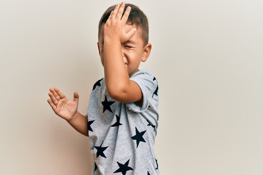 Adorable latin toddler wearing casual clothes surprised with hand on head for mistake, remember error. forgot, bad memory concept.