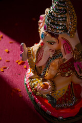 ganesh idol with flower petals	