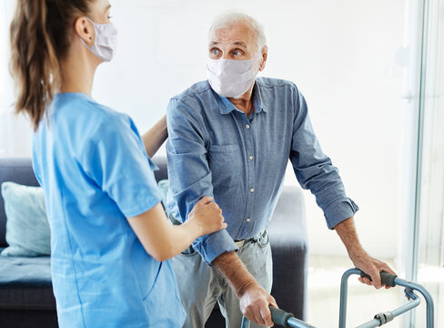 nurse doctor senior care caregiver help walker assistence retirement home nursing man virus mask corona