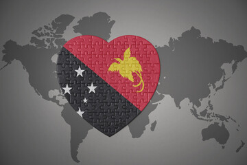 puzzle heart with the national flag of Papua New Guinea on a world map background.