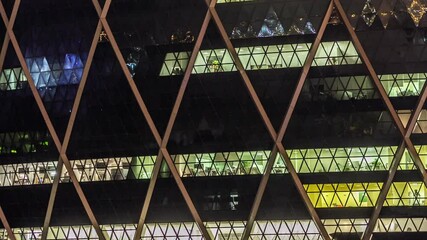 Glowing light in window of the multi-storey building of glass and steel lighting in office timelapse close up view. Abu Dhabi, UAE