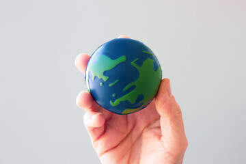 Earth Day. Male hand holding earth in his hands. Human saving planet earth. There is no planet b concept. Earth day concept. Protecting the world is in our hands
