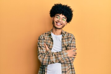Young african american man with afro hair wearing casual clothes happy face smiling with crossed...