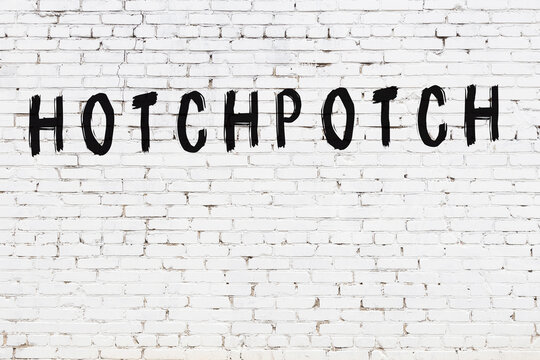 White wall with black paint inscription hotchpotch on it