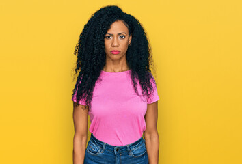 Middle age african american woman wearing casual clothes with serious expression on face. simple and natural looking at the camera.
