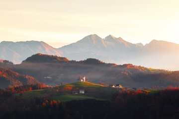 Sveti Tomaz Church (Saint Thomas) on a hilltop at beautiful sunrise in autumn, near Skofja Loka at Upper Carniola region