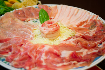 Pork slices on a plate with vegetables ready to eat.