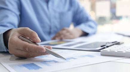 Financial businessman analyze the graph of the company's performance to create profits and growth, Market research reports and income statistics, Financial and Accounting concept.