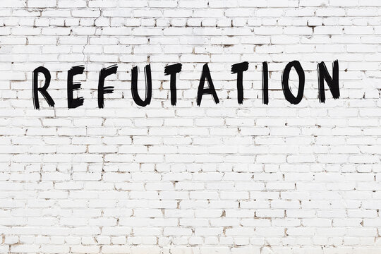 White wall with black paint inscription refutation on it