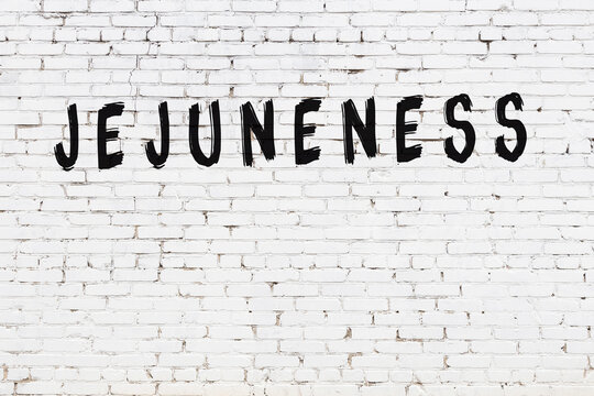 Inscription jejuneness painted on white brick wall