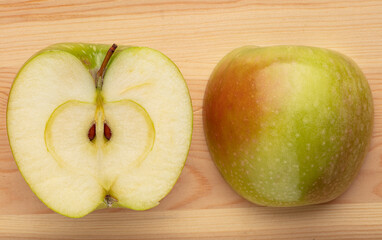 Green sliced apple on a wooden background