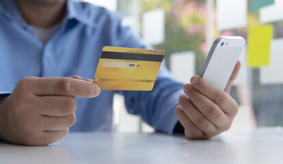 Businessman use mobile phones to register for security Online with a credit card to buy products online through application, Online shopping or Internet technology concept.