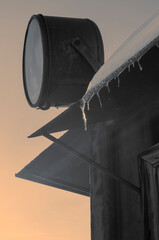Modern abstract urban landscape. Geometric shapes. A lantern on the roof of the house. Snow and icicles.