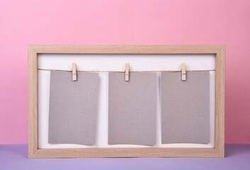 Wooden photo frame with three blank sheets of gray paper on a string where you can write text, Pink...