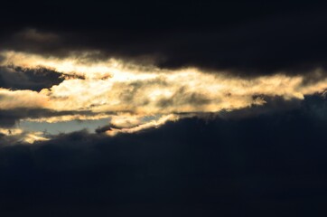 sunrays cutting through thick cloud cover