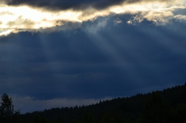 sunrays cutting through thick cloud cover