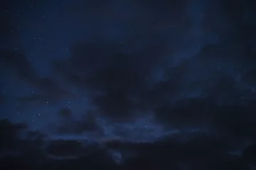 Foto auf Acrylglas Stars in the night sky through the clouds on a summer night © dmitriydanilov62