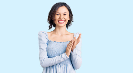 Obraz premium Young beautiful girl wearing casual clothes clapping and applauding happy and joyful, smiling proud hands together