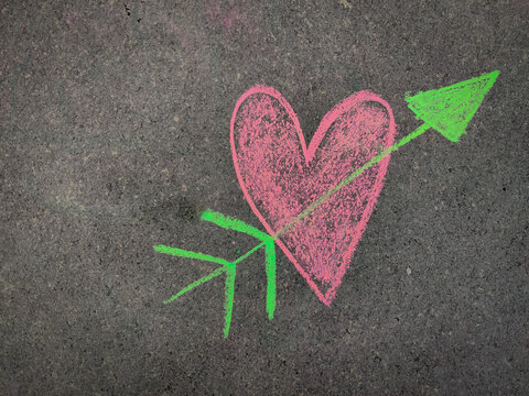 Hand drawn heart or love symbol with arrow. Valentines day concept. Using color chalk pieces.