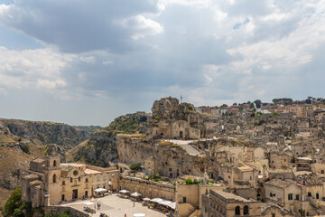 Fototapeta na wymiar Young woman tourist traveling in Italy to Matera ancient city, An UNESCO site