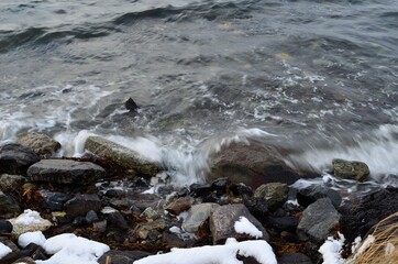 hard waves hitting rocky sea shore in the arctic circle