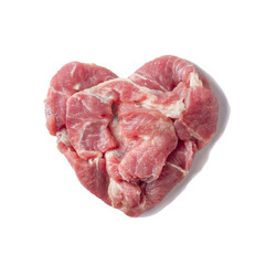 The heart is made from pieces of fresh pork meat. Isolate on a white background