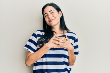 Beautiful young woman wearing casual clothes smiling with hands on chest, eyes closed with grateful gesture on face. health concept.