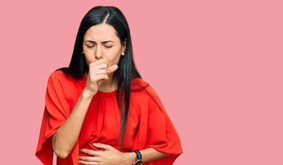 Beautiful young woman wearing casual clothes feeling unwell and coughing as symptom for cold or...