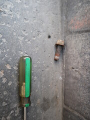 the screwdriver and screw in the dirty background design for handy concept