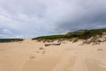 The fisherman boat abandoned in the dunes of Baelo Claudia near Tarifa, Spain, during quarantine...