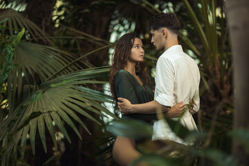Fototapeta na wymiar Romantic Couple in Love Standing in the Tropical Jungle
