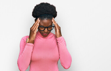 Young african american girl wearing casual clothes and glasses with hand on head for pain in head because stress. suffering migraine.