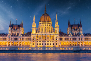 Fototapeta premium Hungarian Parliament along river Danube at dawn with starry sky