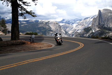 motorcycle riding on Glacier Point Road in Yosemite National Park with Half Dome in the background