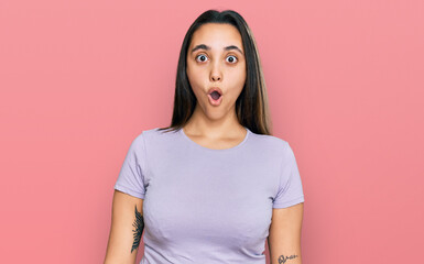 Obraz premium Young hispanic woman wearing casual clothes scared and amazed with open mouth for surprise, disbelief face