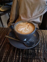 cup with cappuccino on the background of the girl