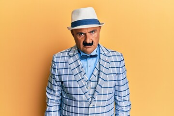 Mature middle east man with mustache wearing vintage and elegant fashion style skeptic and nervous, frowning upset because of problem. negative person.