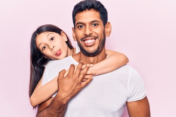 Hispanic young family of father and daughter hugging together with love