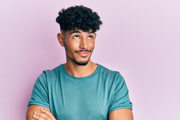 Young arab handsome man wearing casual clothes smiling looking to the side and staring away...