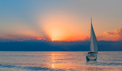 Plakat Sailing Yacht from sail regatta on mediterranean sea at sunset - Sailing luxury yacht with white sails in the Sea.