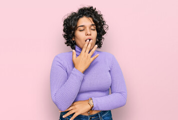 Young hispanic woman with curly hair wearing casual clothes bored yawning tired covering mouth with hand. restless and sleepiness.