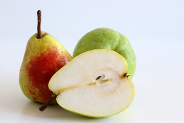 Pears harvest. Fruit background. Fresh organic pears on white table. Pear autumn harvest. Juicy, flavorful pears of a white background. Autumn nature concept.
