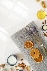 Relax concept. Cozy, comfortable, knitted blanket with a bouquet of lavender, a glass of milk and healthy snack for good sleep. Insomnia or depression treatment for sleepless nights. Top view