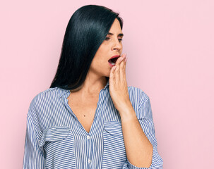 Young caucasian woman wearing casual clothes bored yawning tired covering mouth with hand. restless and sleepiness.