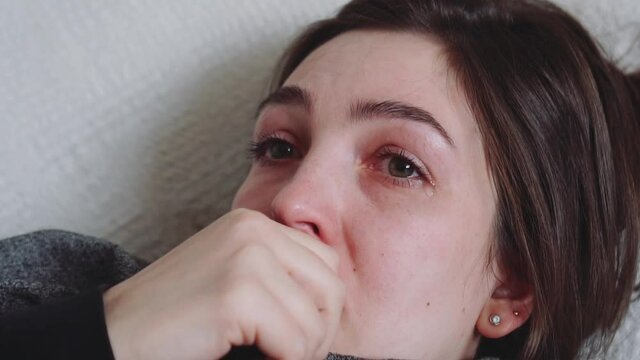Young woman suffering from depression. The girl experiences sadness, crying, tears