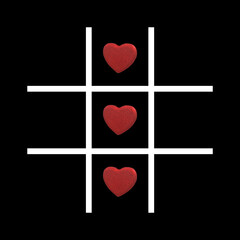 Playing tic-tac-toe, also called naughts and crosses, with heart shaped stones.